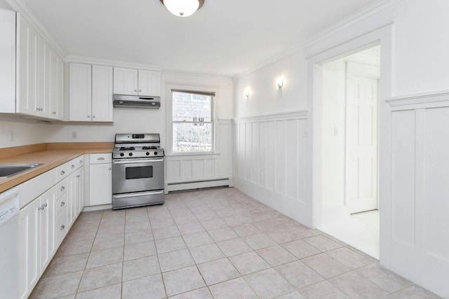 kitchen with stainless steel gas range, baseboard heating, crown molding, light tile patterned floors, and white cabinets