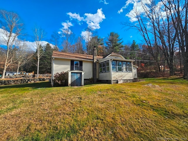 back of house featuring a lawn