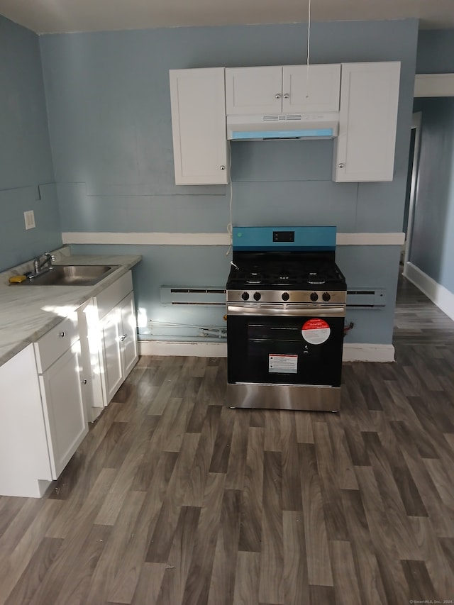 kitchen with dark hardwood / wood-style floors, white cabinetry, sink, and stainless steel range oven