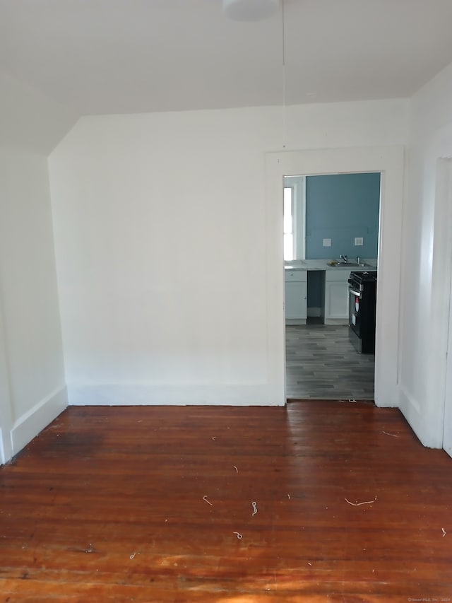 unfurnished room featuring dark wood-type flooring