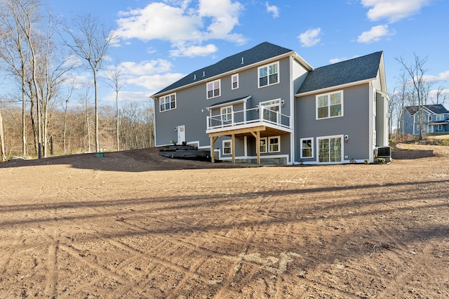 rear view of property with a deck and central AC