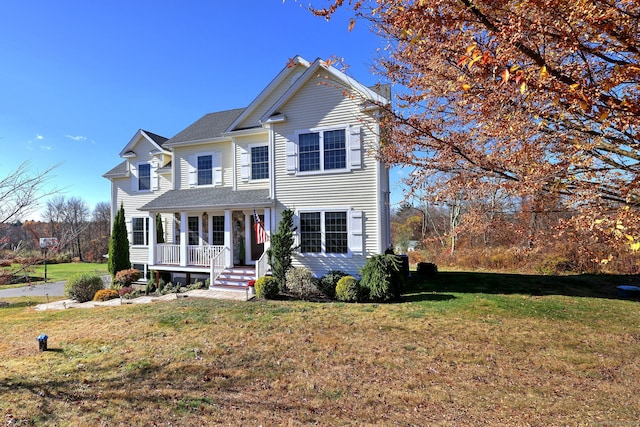 front of property featuring covered porch and a front yard