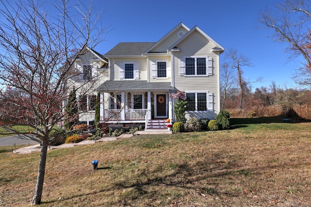 view of front facade with covered porch and a front lawn