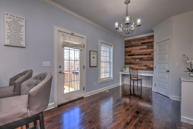 home office with dark hardwood / wood-style flooring, wooden walls, an inviting chandelier, and crown molding