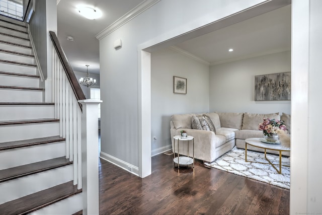 living room with a chandelier, dark hardwood / wood-style floors, and ornamental molding