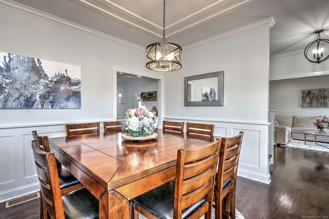 dining space featuring a notable chandelier, dark hardwood / wood-style floors, and ornamental molding