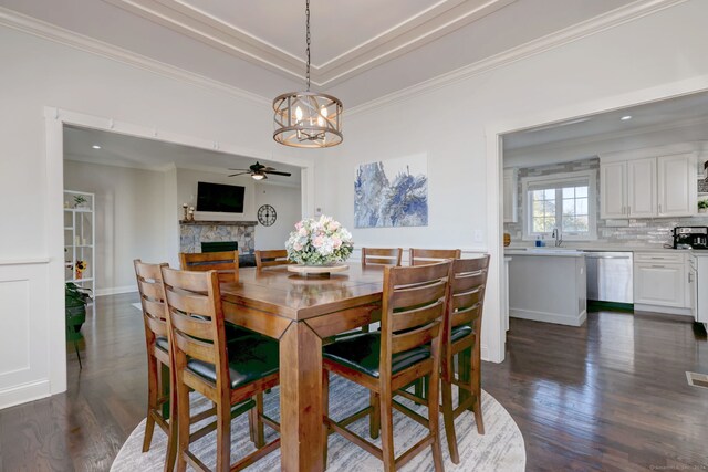 dining space featuring dark hardwood / wood-style flooring and ornamental molding