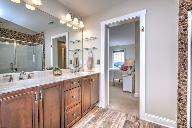 bathroom featuring vanity, an enclosed shower, and wood-type flooring