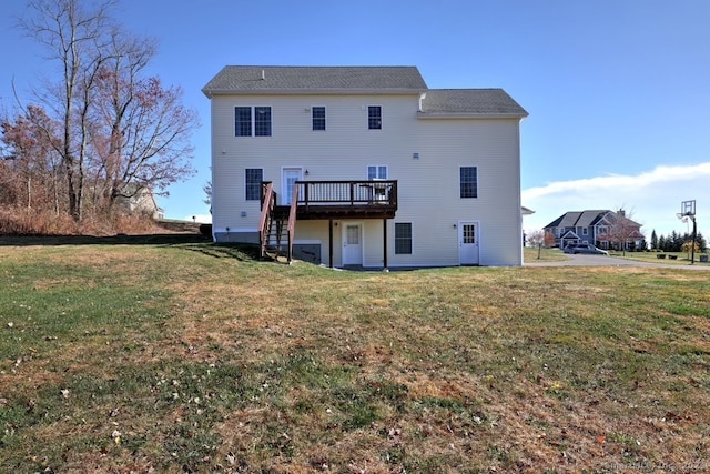 rear view of property featuring a yard and a deck