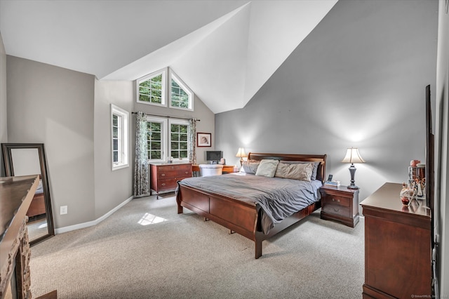 bedroom featuring light carpet and high vaulted ceiling