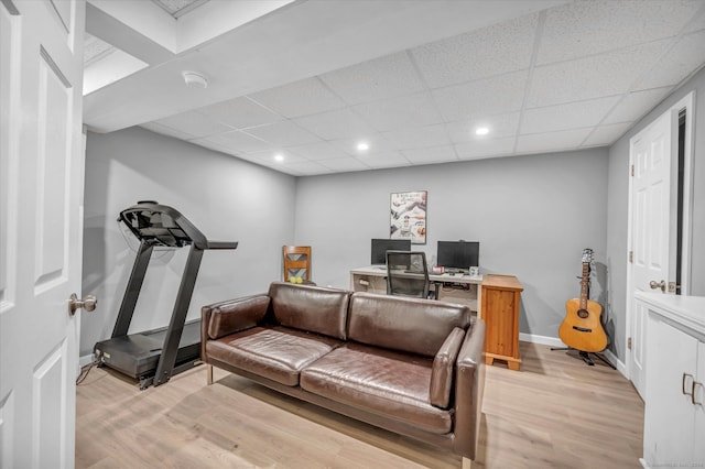 office featuring a paneled ceiling and light hardwood / wood-style flooring