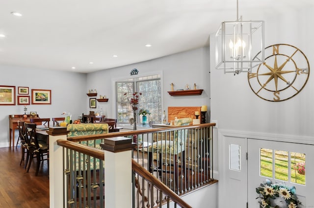 interior space with wood-type flooring and a notable chandelier