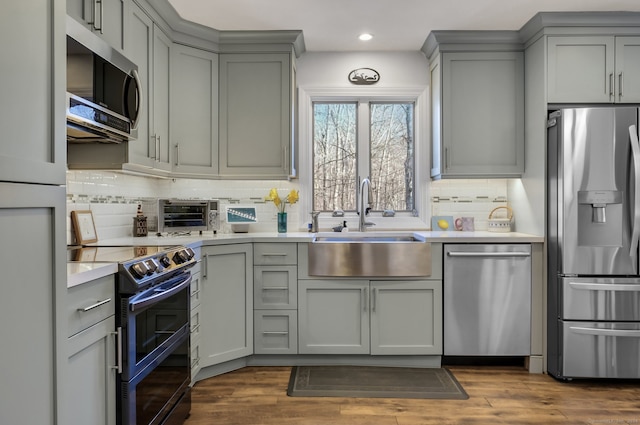 kitchen featuring gray cabinets, dark hardwood / wood-style flooring, and appliances with stainless steel finishes