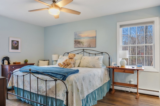 bedroom featuring hardwood / wood-style flooring, multiple windows, and ceiling fan