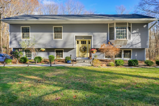 split foyer home with a front lawn