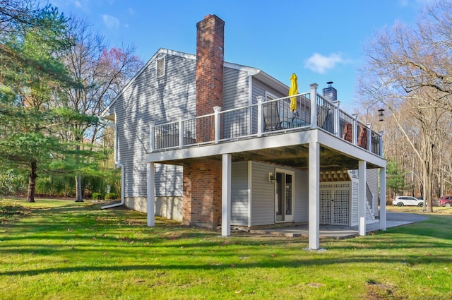 rear view of house with a lawn and a patio