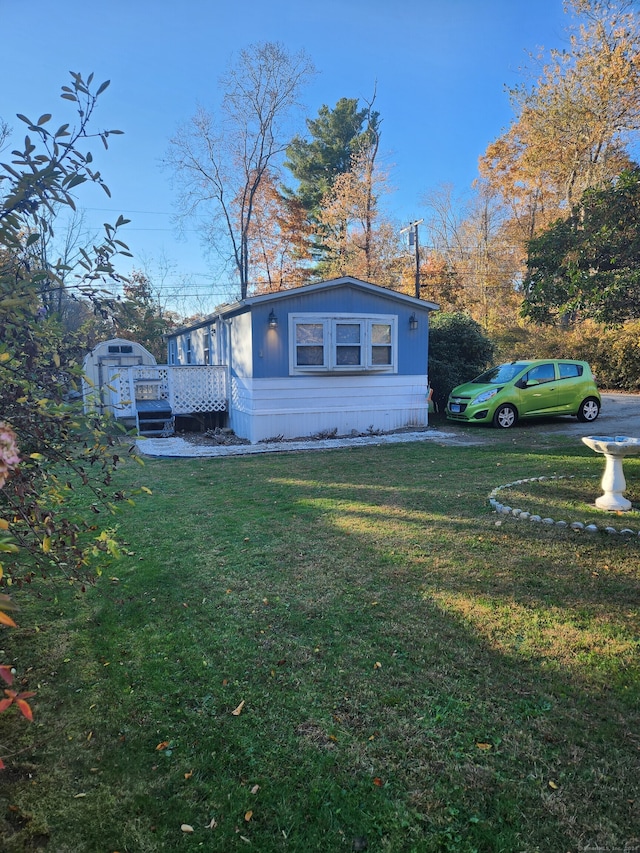 view of home's exterior with a deck and a lawn