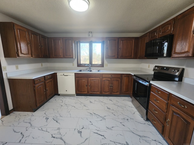 kitchen featuring dishwasher, a textured ceiling, sink, dark brown cabinets, and stainless steel electric range oven