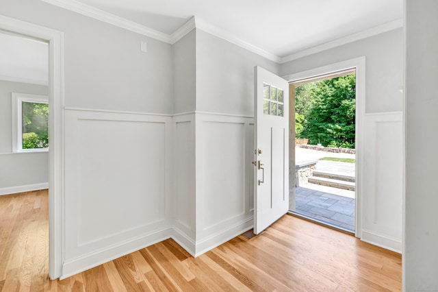7 Topping Ln, Norwalk, CT 06854 - foyer entrance featuring light wood-style flooring, a decorative wall, plenty of natural light, a wainscoted wall, and crown molding