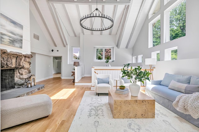7 Topping Ln, Norwalk, CT 06854 - living room with high vaulted ceiling, beamed ceiling, wood finished floors, a fireplace, and baseboards