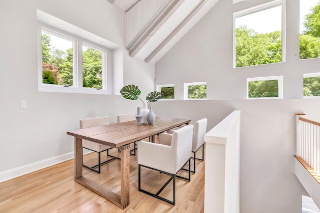 7 Topping Ln, Norwalk, CT 06854 - dining room featuring high vaulted ceiling, baseboards, and wood finished floors