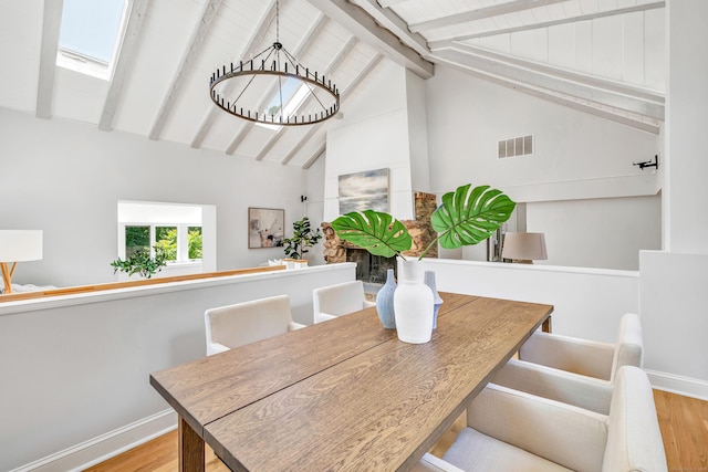 7 Topping Ln, Norwalk, CT 06854 - dining area with wood finished floors, beamed ceiling, baseboards, and high vaulted ceiling