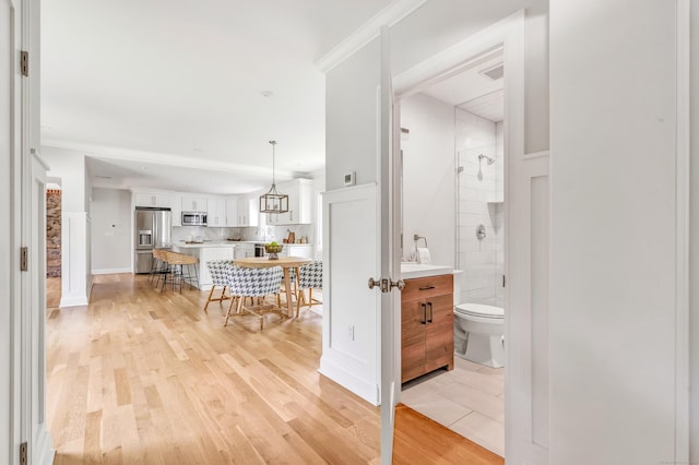 7 Topping Ln, Norwalk, CT 06854 - hall featuring light wood finished floors and crown molding