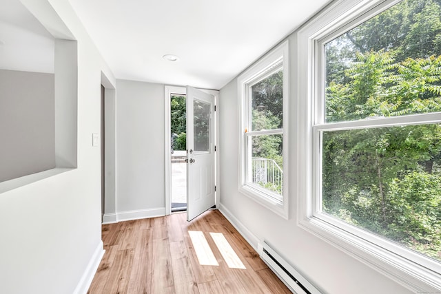 7 Topping Ln, Norwalk, CT 06854 - doorway to outside with light wood-style floors, baseboards, healthy amount of natural light, and a baseboard heating unit
