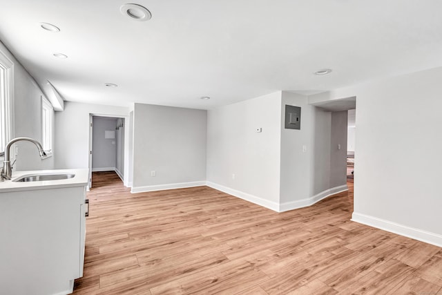 7 Topping Ln, Norwalk, CT 06854 - unfurnished living room with a sink, light wood finished floors, baseboards, electric panel, and recessed lighting