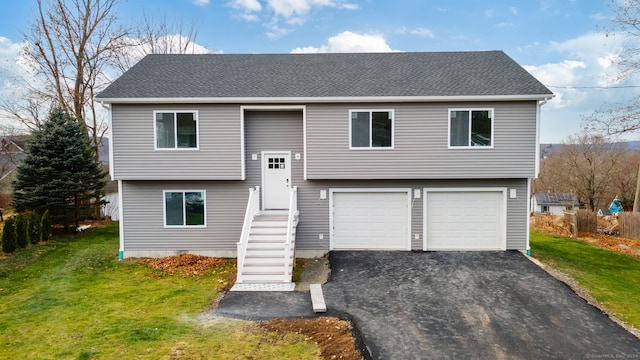 split foyer home with a front yard and a garage