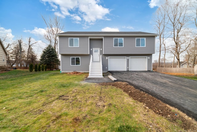 bi-level home with a garage and a front lawn