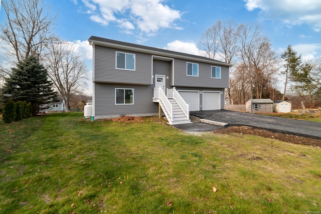 split foyer home featuring a front yard and a garage