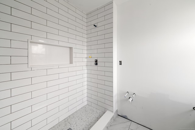 bathroom with tiled shower