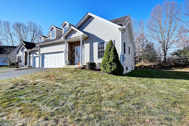 view of front of home featuring a front yard and a garage