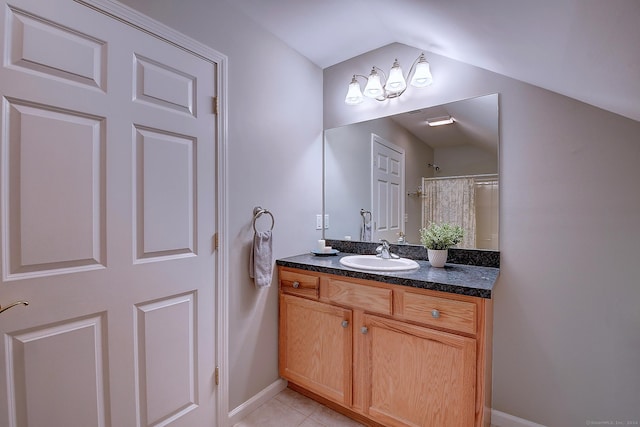 bathroom with tile patterned floors, vanity, lofted ceiling, and a shower with curtain