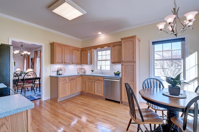 kitchen with decorative light fixtures, stainless steel appliances, and a wealth of natural light