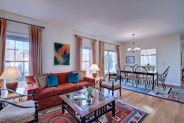 living room featuring wood-type flooring and an inviting chandelier