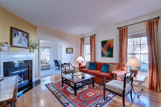 living room with light wood-type flooring and plenty of natural light