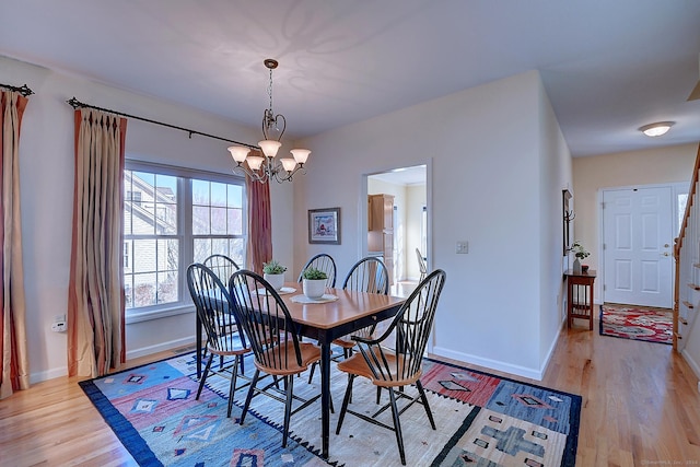 dining area featuring a chandelier and light hardwood / wood-style flooring