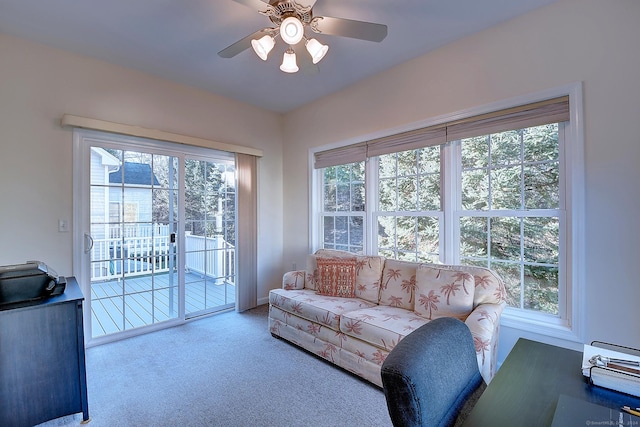 living room with ceiling fan, a healthy amount of sunlight, and light colored carpet