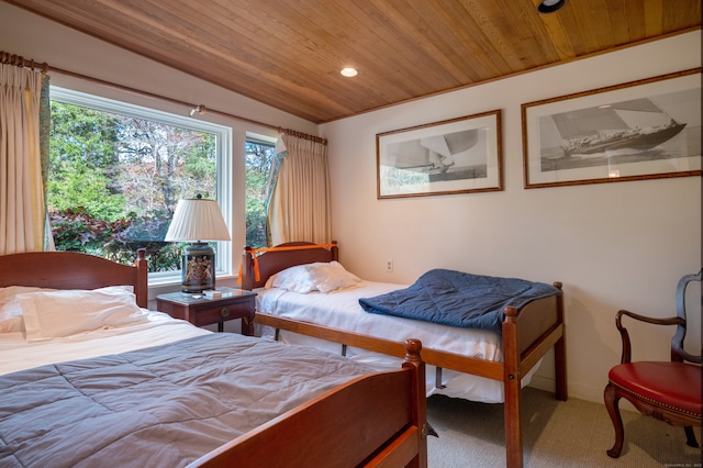 bedroom featuring wooden ceiling and carpet flooring