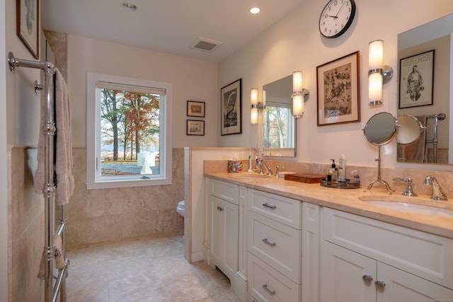 bathroom featuring tile patterned flooring, plenty of natural light, vanity, and toilet