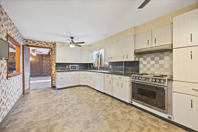 kitchen with decorative backsplash, white appliances, sink, and ceiling fan