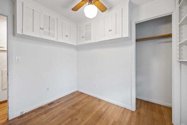 interior space featuring hardwood / wood-style flooring, ceiling fan, and a closet