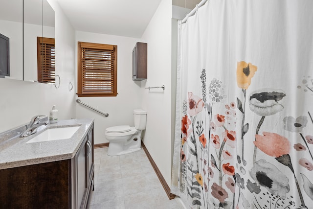 bathroom featuring vanity, a shower with shower curtain, tile patterned floors, and toilet