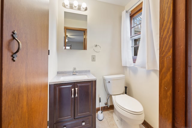 bathroom with vanity, tile patterned flooring, and toilet