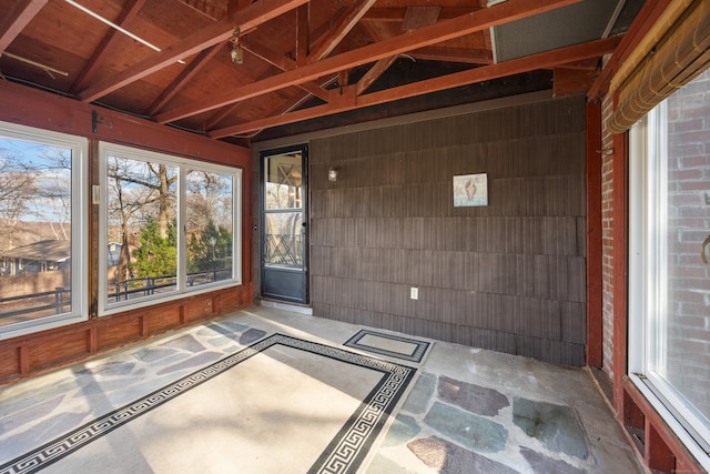 unfurnished sunroom with vaulted ceiling