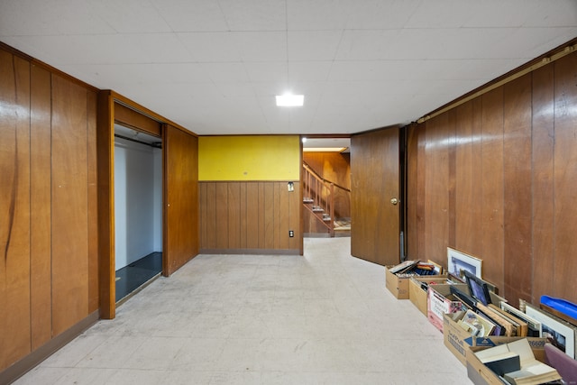 basement featuring wooden walls