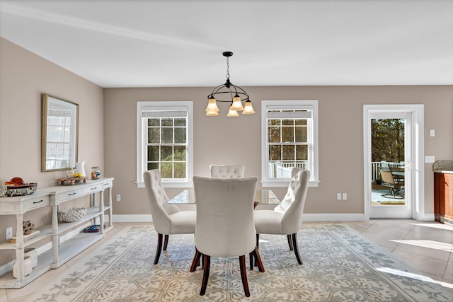 dining space featuring light tile patterned floors and a notable chandelier