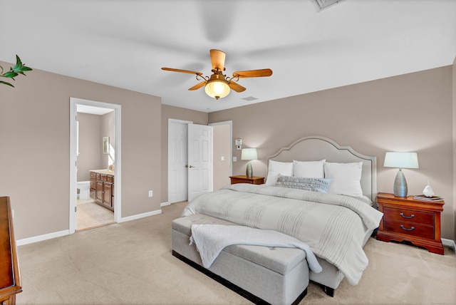 carpeted bedroom with ceiling fan and ensuite bath